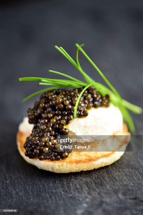 Blini With Sour Cream And Real Black Caviar High-Res Stock Photo - Getty Images