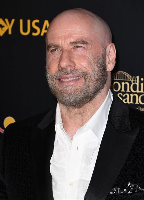 John Travolta debuts new shaved head