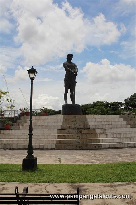 Lapu-lapu monument side view with clouds and flowers deside the ...