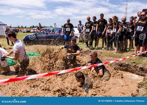 Muddy Obstacle Race Runner In Action. Mud Run Editorial Image ...