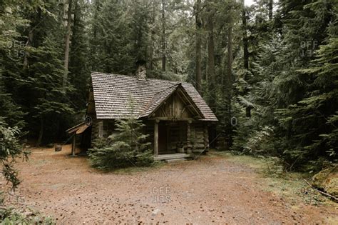 Rustic log cabin in the woods stock photo - OFFSET