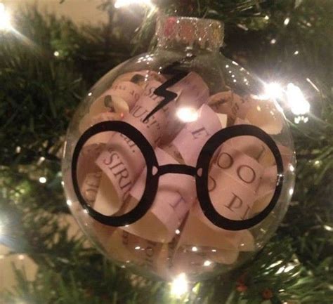 a harry potter ornament hanging from a christmas tree with glasses on it's side