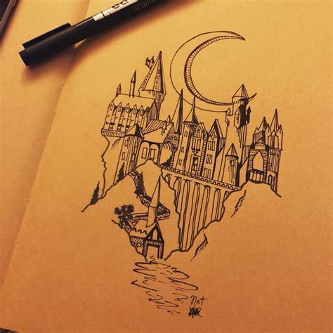 a drawing of a castle with a moon and stars on it's side, next to a pen