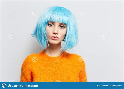 Studio Portrait of Beauty Girl with Blue Hair in Orange Sweater on ...