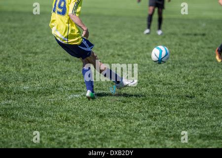 Teen boys soccer action Stock Photo - Alamy