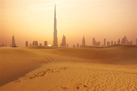 Dubai city skyline at sunset seen from the desert - Pure Vacations