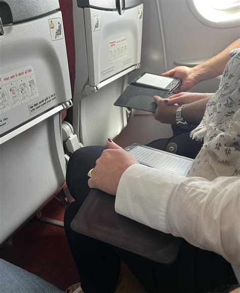 Loving couple reading adorable old Kindle models together on a plane ...