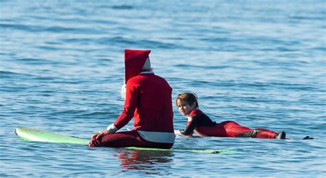 Surfing Santas bring cheer, stoke to local beaches – Orange County Register