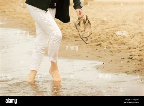 Walking barefoot on the beach Stock Photo - Alamy