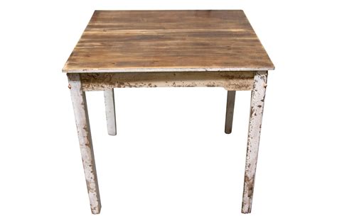 an old wooden table with peeling paint on the top and bottom, against a white background