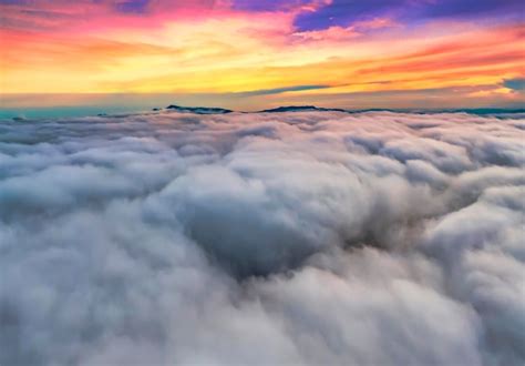 Premium Photo | Aerial view of colorful sunrise over white dense fog ...