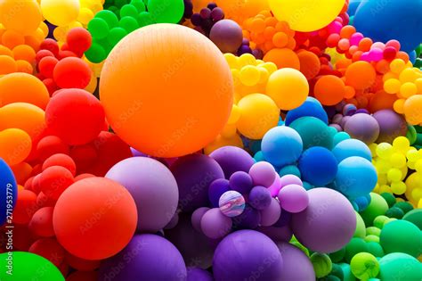 Jumble of rainbow colored balloons celebrating gay pride in a textured ...