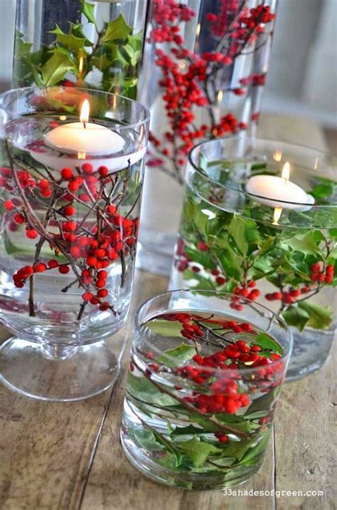 clear glass vases, berries and greenery and floating candles Christmas ...