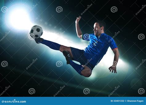 Soccer Player In Mid Air Kicking The Soccer Ball, Stadium Lights At ...