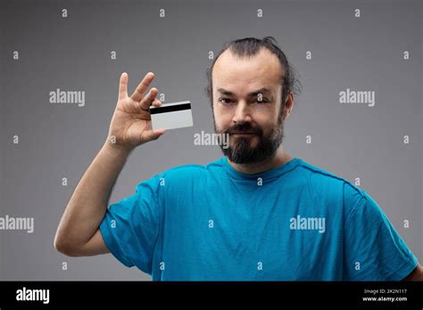 Bearded man showing blank credit card Stock Photo - Alamy