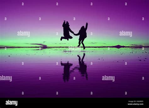 Pop art styled purple and green colored a silhouette of happy couple jumping on the MIRROR ...