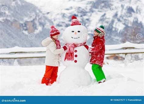 Child Building Snowman. Kids Build Snow Man Stock Image - Image of nature, outdoors: 163627577