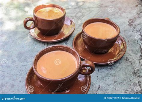 Three Cups of Traditional Nepalese Tea with Milk and Spices in Brown ...