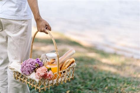 Premium Photo | Couple walking in garden with picnic basket in love ...