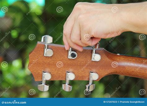 Tuning the guitar strings stock image. Image of close - 57207023