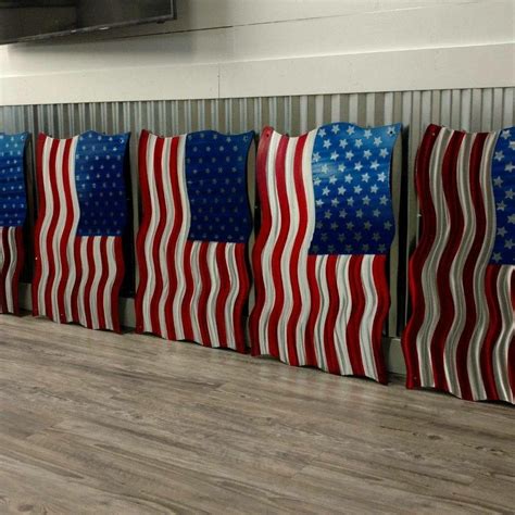 four american flags are lined up on the floor in front of a flat screen tv