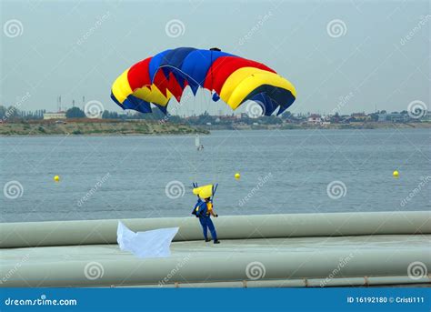 Parachutist Landing on Lake Stock Photo - Image of hand, blue: 16192180