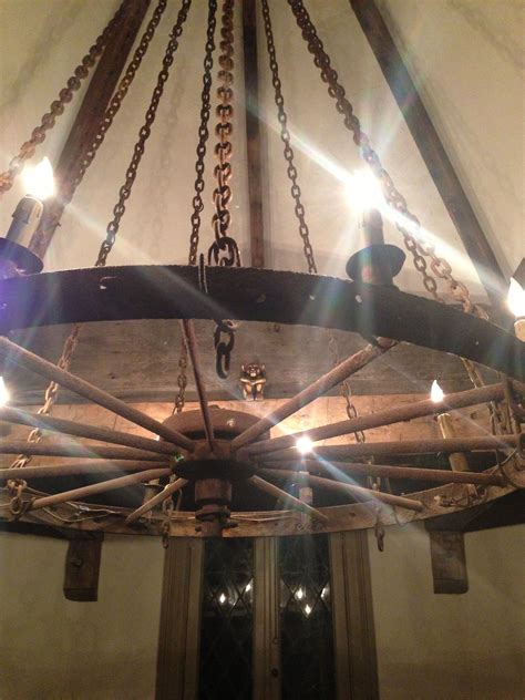 The kitchen light is an old wagon wheel chandelier suspended by chains from the turret center ...