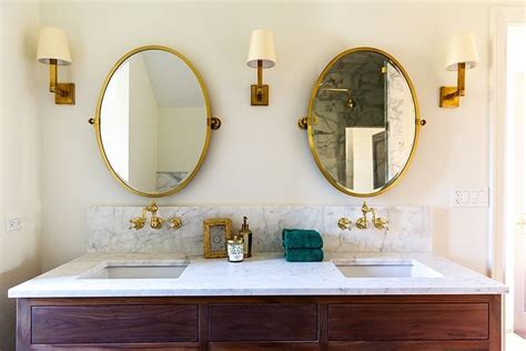 Bathroom Brass Mirror Bathroom with oval brass mirrors over brass mounted faucets, Waterworks ...