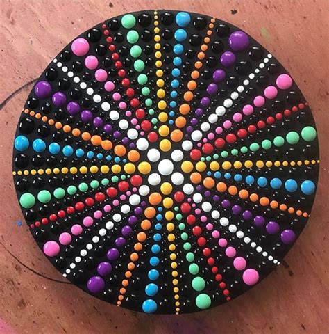 a colorful object is sitting on the floor with beads all over it's surface