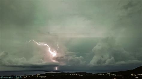 Lightning strikes the ocean behind island... - YouTube