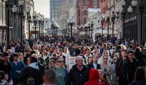 People walk along Moscow's Arbat street this weekend. Russia says eight million citizens have ...