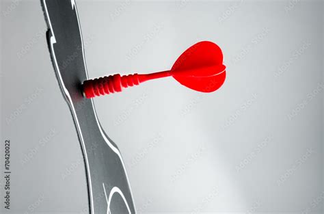 red arrow at dart board in profile shape on grey background Stock Photo ...