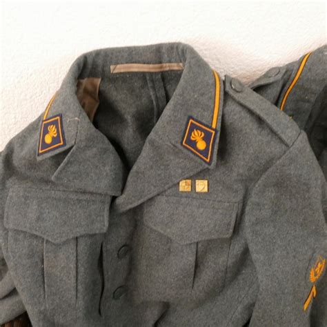 3 Swiss Military Uniforms, jackets and trousers with emblems - Catawiki