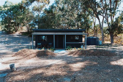 Log cabins nestle behind the sand dunes in Western Australia - The Spaces