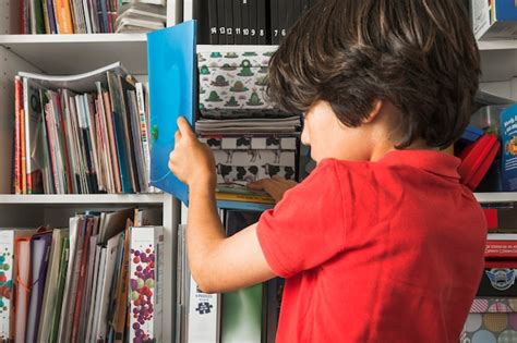 Free Photo | Kid taking book from shelf