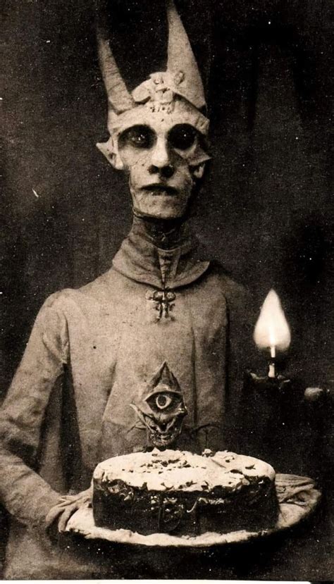 an old black and white photo of a demon holding a cake with candles in ...