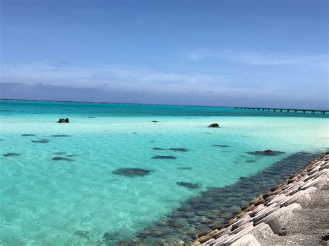 the water is crystal blue and clear with rocks in front of it, as well ...