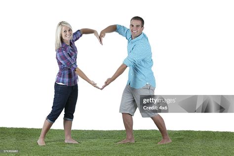 Young Couple Making Heart Shape With Their Hands High-Res Stock Photo ...