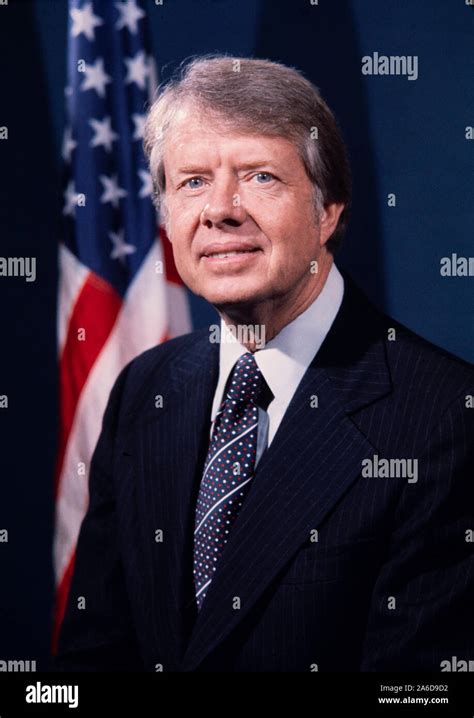 Portrait of President Jimmy Carter in dark suit with US flag in ...