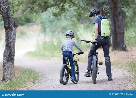 Family biking in the park stock image. Image of family - 113195223