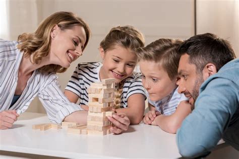 Family Playing Jenga Game at Home Together Stock Photo - Image of women ...