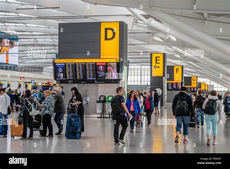 Busy scene inside the London Heathrow Airport Terminal 5 building check ...