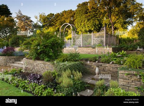 Terracing with herbaceous border, plants, trellis arch & bird bath - beautiful, designed ...