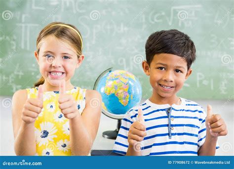 Portrait Of Smiling School Kids Showing Thumbs Up In Classroom Royalty ...