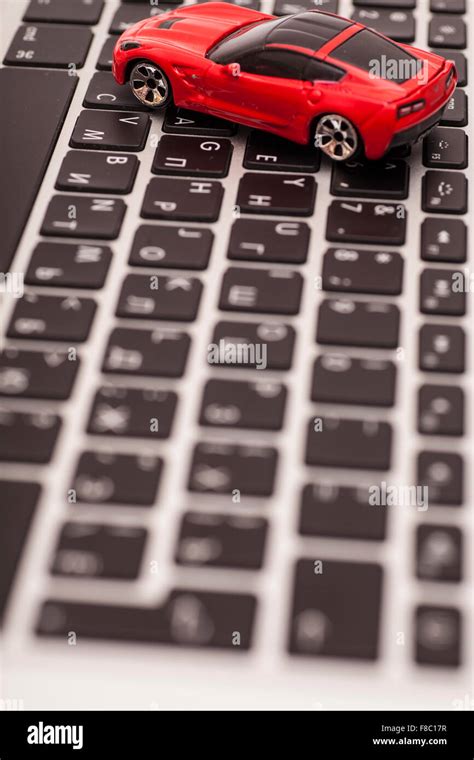 Toy car over laptop keyboard Stock Photo - Alamy