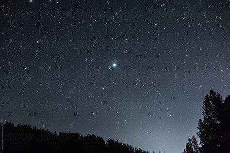 Very bright star in the night sky. by Justin Mullet - Stocksy United