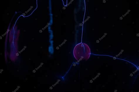 Premium Photo | A blue jellyfish is shown in the dark.