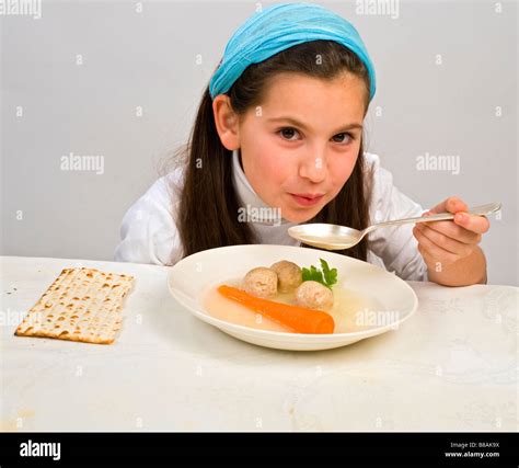 Jwish girl eating a matzo ball soup in passover Stock Photo - Alamy