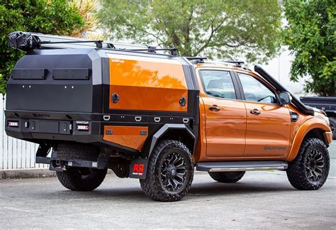 an orange and black truck is parked on the street