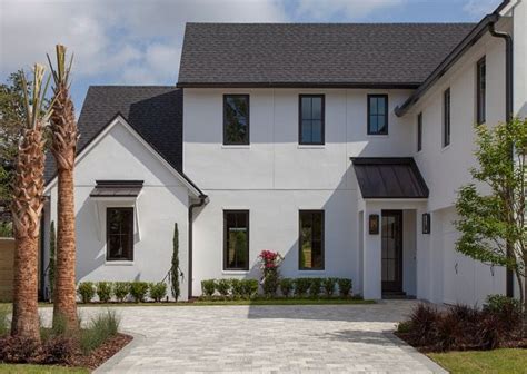 Modern Farmhouse with white stucco, black windows and black roof Modern Farmhouse with white ...